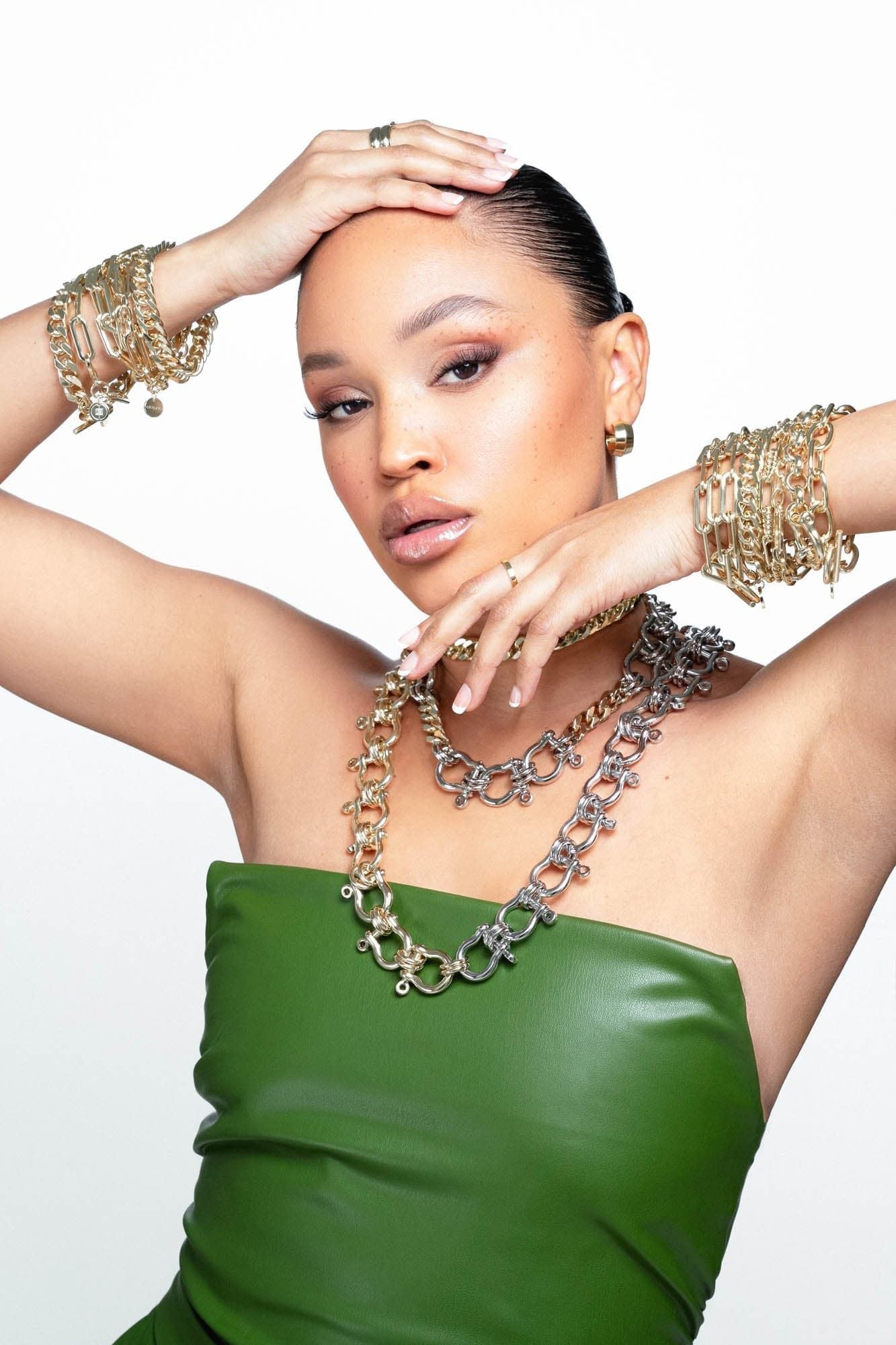 Model wearing many bracelets and neckless including Two Toned Xl Harrison Necklace