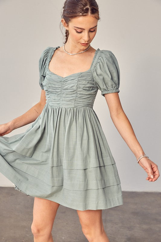 Model showing hem of the FRONT RUCHED DETAIL PUFF SLEEVE DRESS