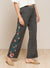 Close up view of the flowers on LONG FLORAL EMBROIDERED WIDE LEGGED PANTS