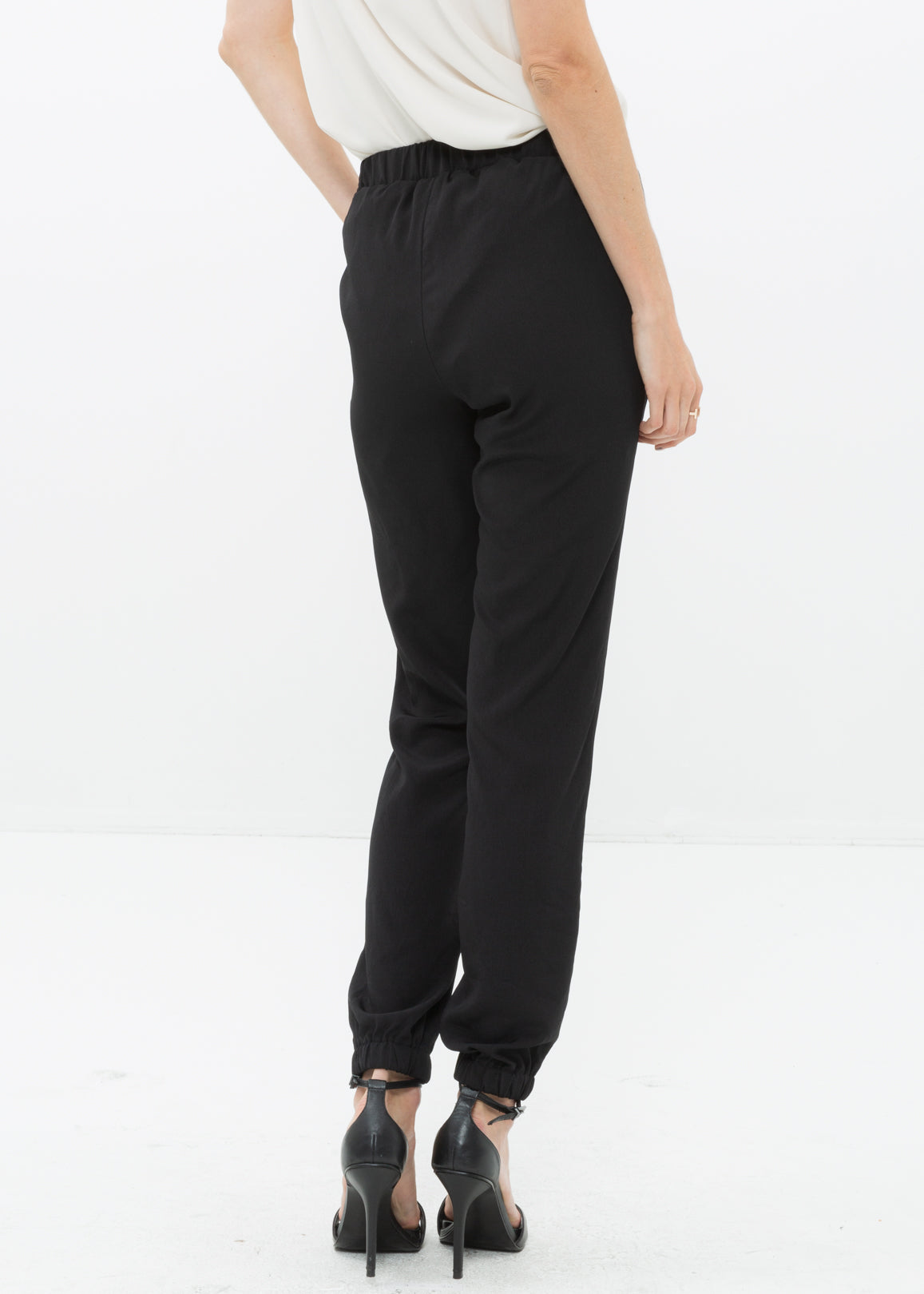 Back view of Women&#39;s Ankle Cuffed Black Crepe Pants In Black