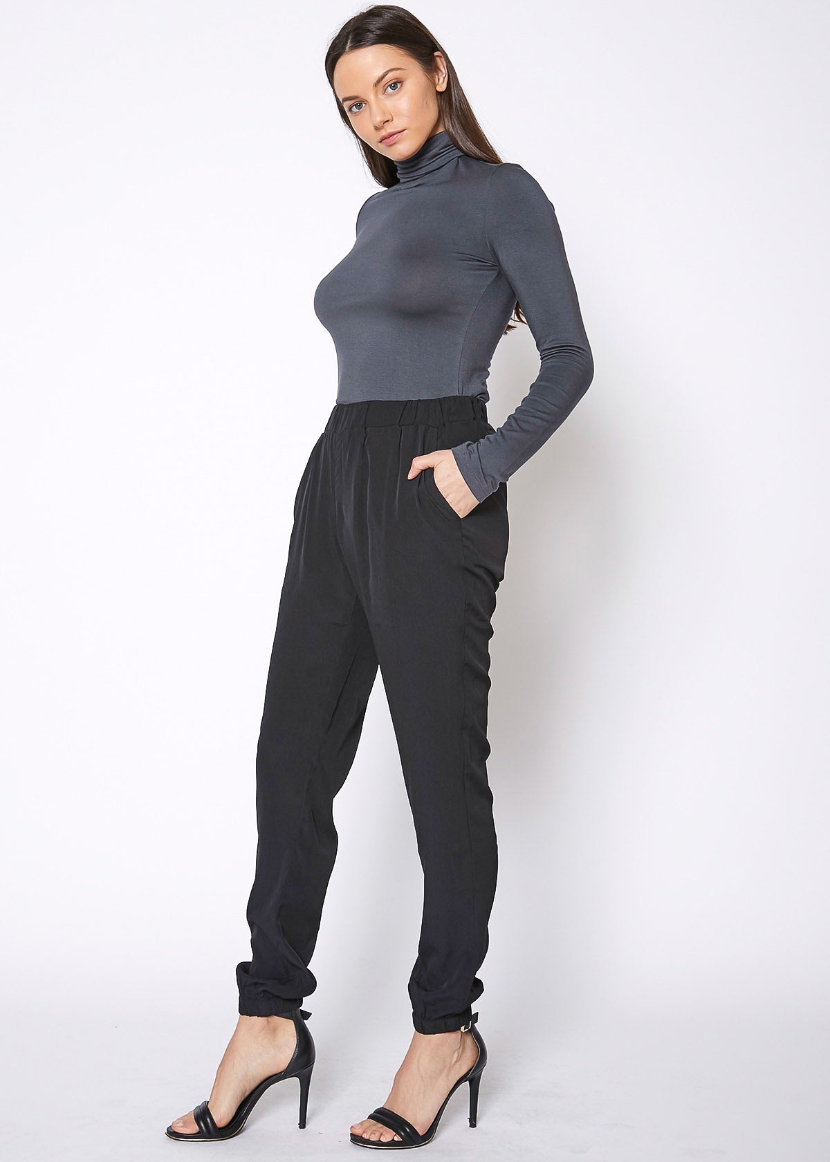 Model showing pockets on Women&#39;s Ankle Cuffed Black Crepe Pants In Black