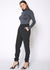 Model showing pockets on Women's Ankle Cuffed Black Crepe Pants In Black