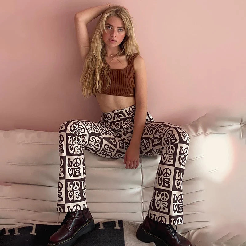 Model sitting on a sofa showing LOVE High Waisted Trousers